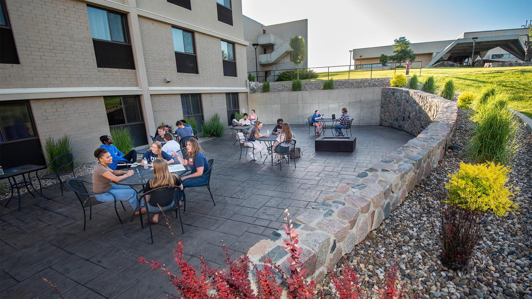 Students sitting outside in one of the courtyards on campus.